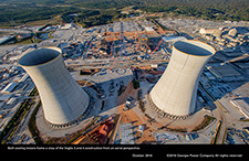 Both cooling towers frame a view of the Vogtle 3 and 4 construction from an aerial perspective.