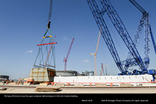 The heavy lift derrick begins to move the upper condenser shell for the Unit 4 turbine building.