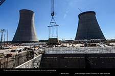 The heavy lift derrick begins to move the upper condenser shell for the Unit 4 turbine building.