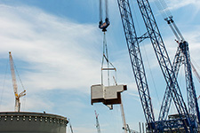 The heavy lift derrick moves the 90-ton CA05 module toward the Unit 4 containment building.