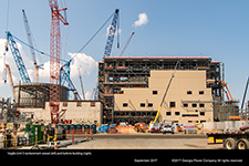 Vogtle Unit 3 containment vessel (left) and turbine building (right).