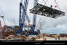 After a traditional Topping Out ceremony, the final roof truss is lifted to the top of the Unit 3 turbine building.